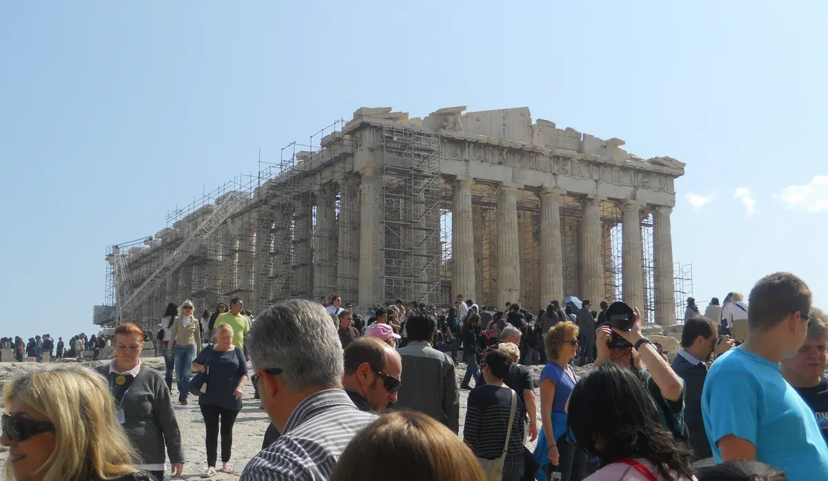 Visitors crossing the open Acropolis rock in high summer, Athens, Greece