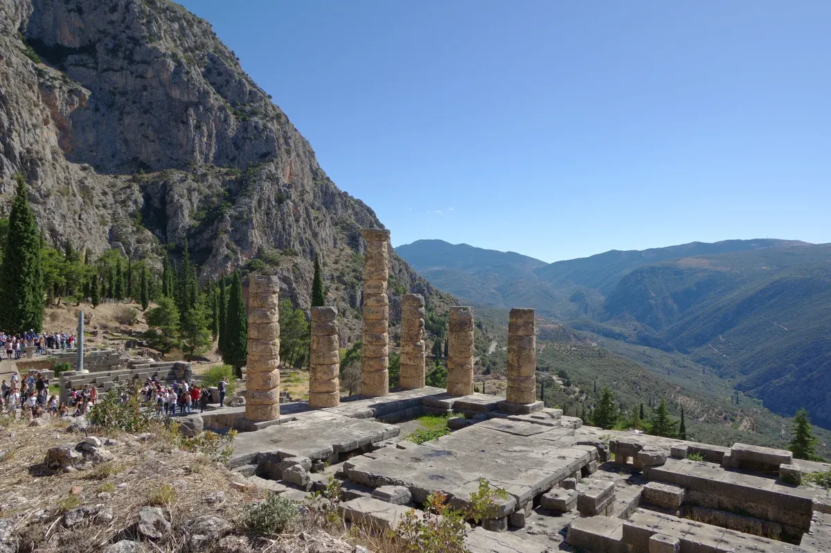 The columns of the Temple of Apollo in the sanctuary at Delphi, a day trip from Athens, Greece