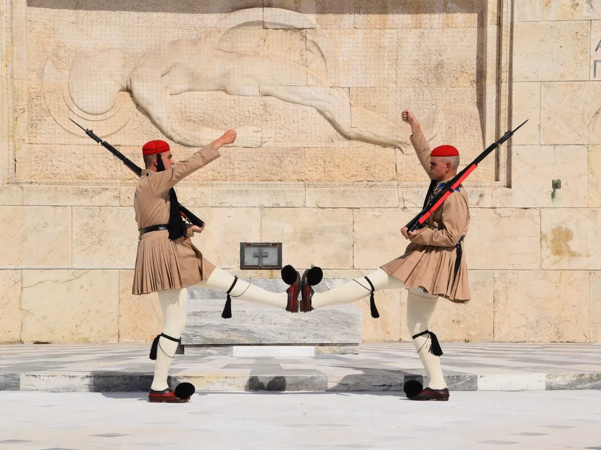Evzones of the Presidential Guard high-stepping at the changing of the guard in Syntagma, Athens with kids, Greece